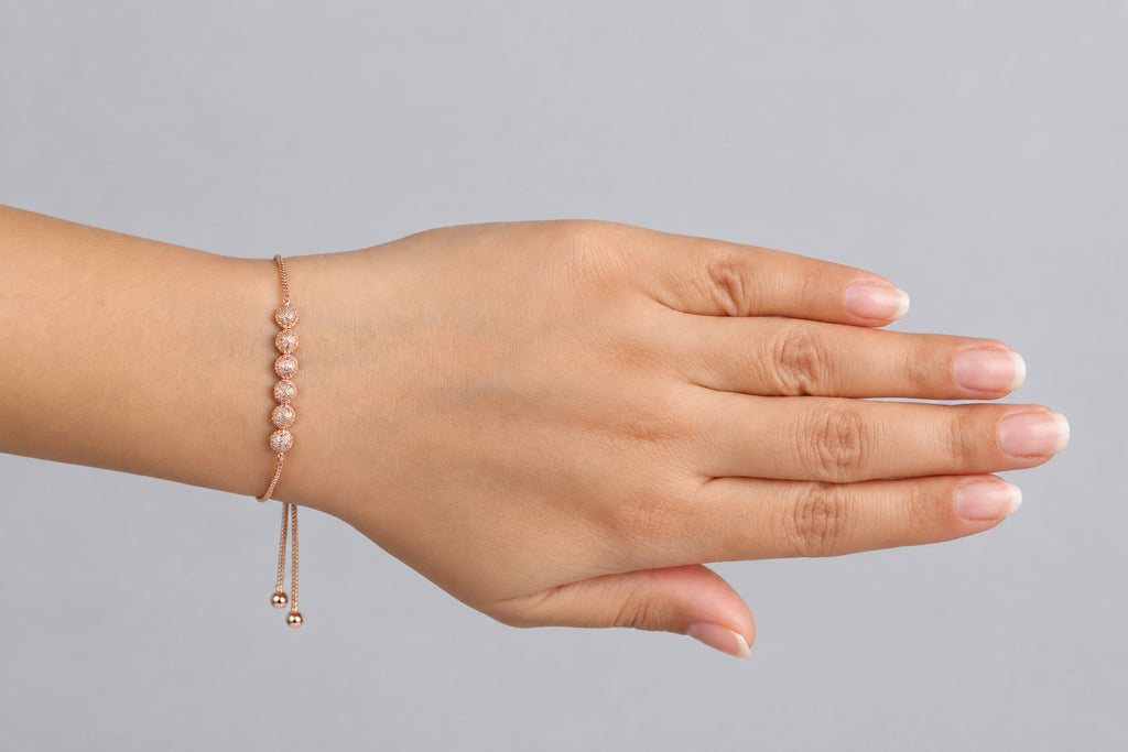 Six textured- bead adjustable bolo bracelet 18K rose gold finish